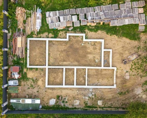 Aerial view of building site for future brick house, concrete foundation floor