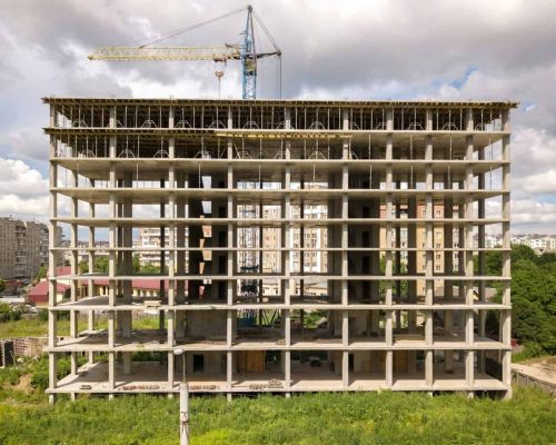 Aerial view of high frame of monolithic concrete building under construction. Real estate