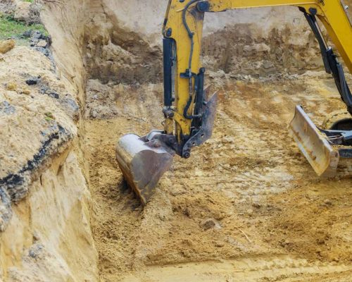 Construction with pile foundation at ground completed on excavator at earthworks