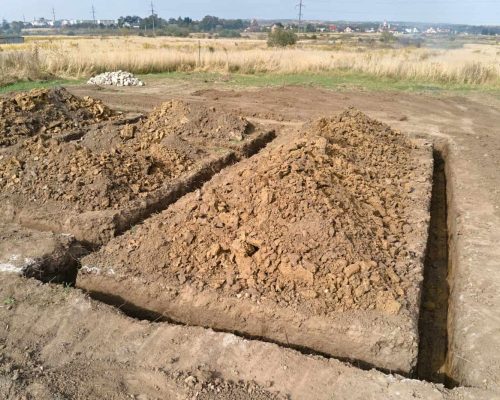 Dug out trench for building works of new house concrete foundation on construction site